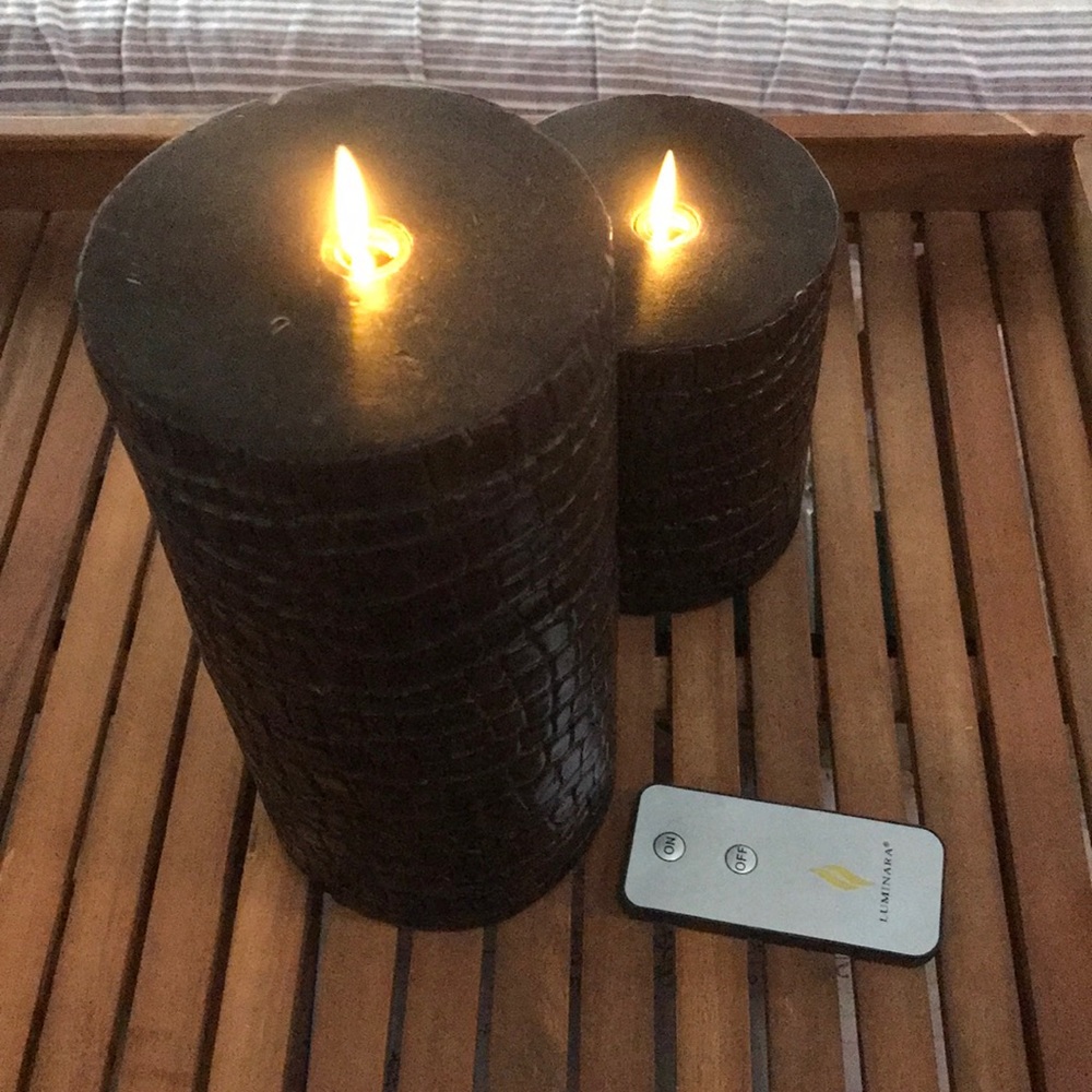 two black “alligator”  Luminara branded candles, unscented wax , remote.